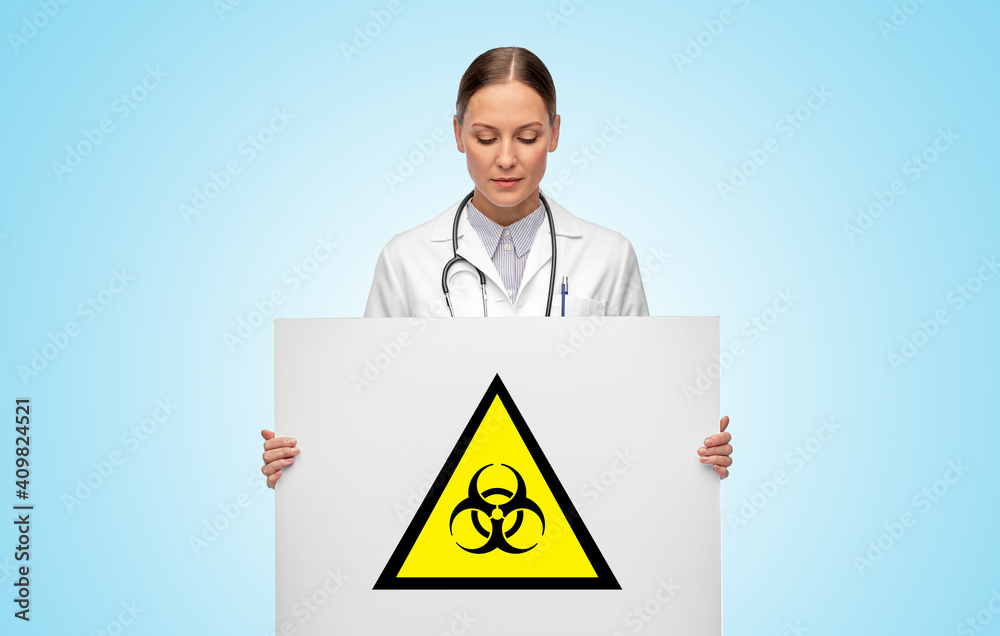 medicine, science and healthcare concept - female doctor holding white board with biohazard sign over blue background medicine, science and healthcare concept - female doctor holding white board with biohazard sign over blue background