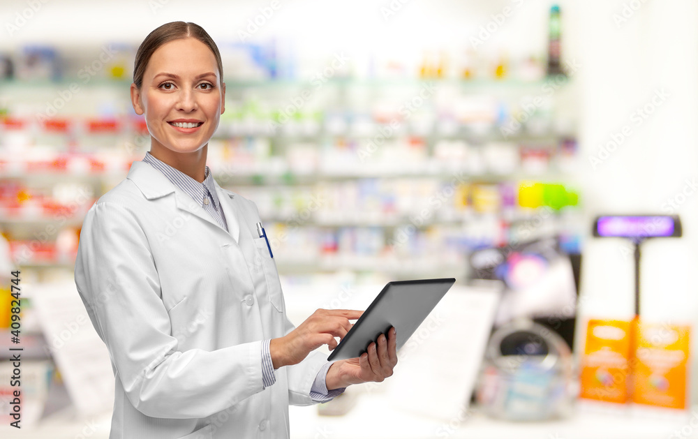 medicine, profession and healthcare concept - happy smiling female doctor or pharmacist in white coat with tablet pc computer over pharmacy background