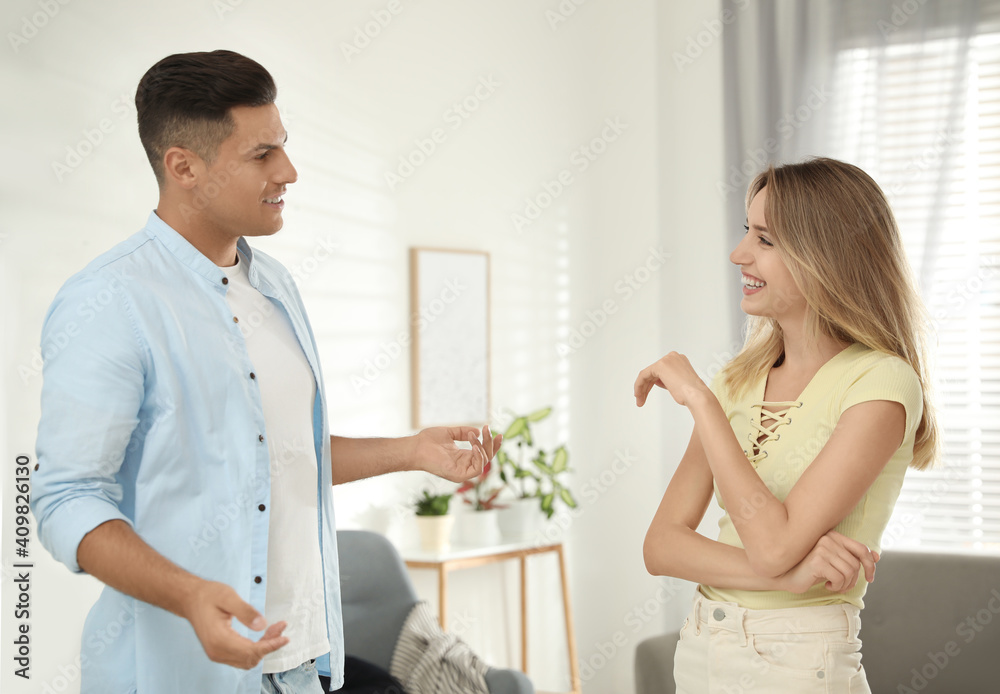 Man and woman talking in living room Man and woman talking in living room