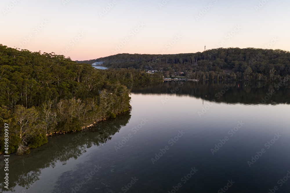 aerial of sunset over glassy lake