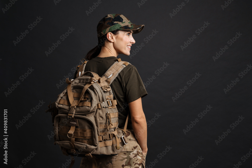 Confident soldier woman posing with backpack Confident soldier woman posing with backpack