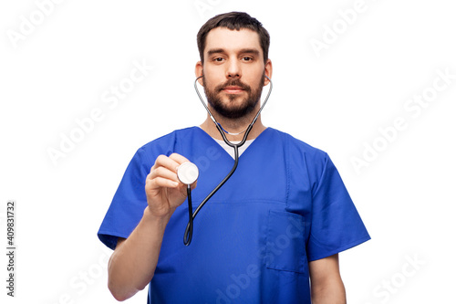 healthcare, profession and medicine concept - doctor or male nurse in blue uniform with stethoscope over white background