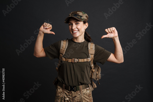 Confident soldier woman posing with backpack