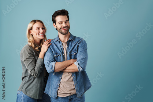 Young happy couple hugging and smiling while looking aside