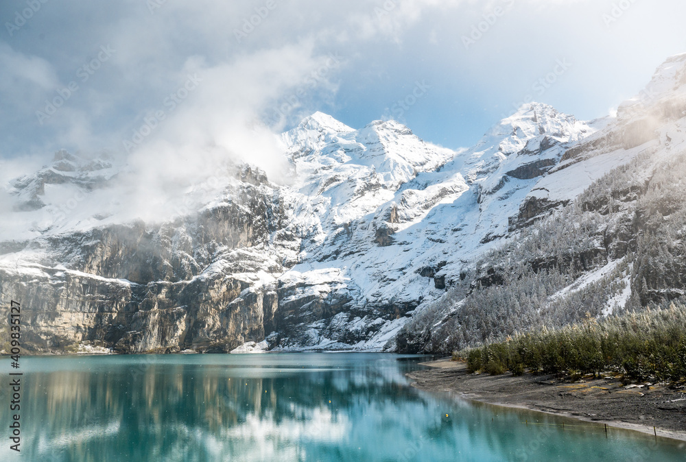 early winter with first snow at mountain lake Oeschinensee