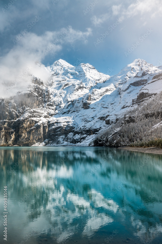 early winter with first snow at mountain lake Oeschinensee Stock Photo ...
