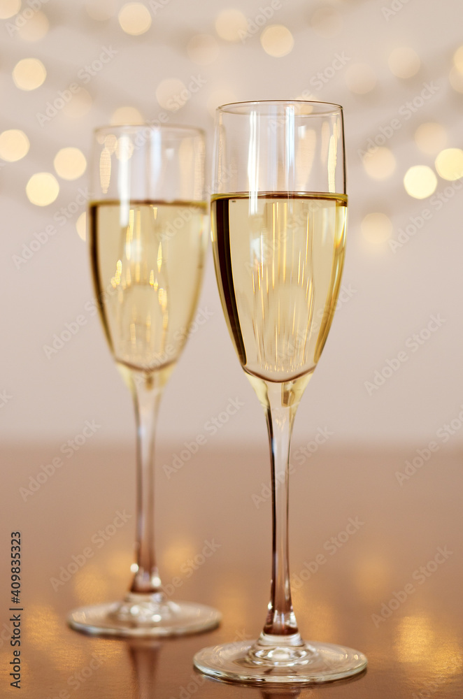 Two glasses of wine with bokeh background close up. Top view. New Year, Christmas mood. Greeting card. Party and holiday celebration concept. Two glasses of wine with bokeh background close up. Top view. New Year, Christmas mood. Greeting card. Party and holiday celebration concept.