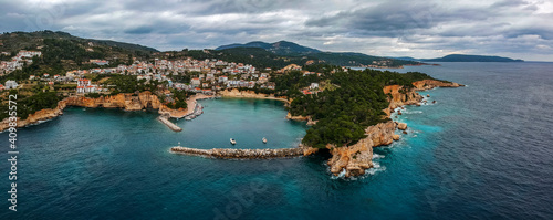 Aerial view over Votsi beach (Paralia Votsi) and the picturesque port with traditional wooden fishing boats in Alonnisos island during Winter period in Sporades, Greece
