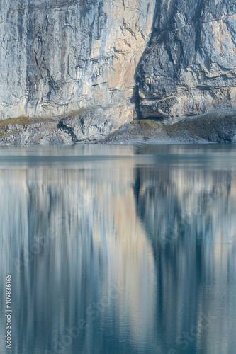 artistic reflection of a rock face in Oeschinensee