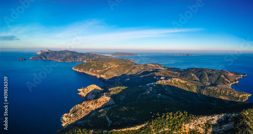 Aerial drone view over western Alonnisos towards Skopelos island at sunset. Natural landscape, beautiful rocky scenery, spectacular view in Sporades, Aegean sea, Greece © panosk18