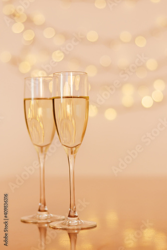 Two glasses of wine with bokeh background close up. Top view. New Year, Christmas mood. Greeting card. Party and holiday celebration concept.