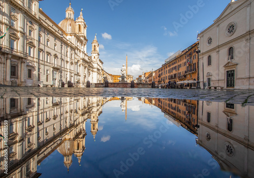  Rome, Italy - in Winter time, frequent rain showers create pools in which the wonderful Old Town of Rome reflect like in a mirror. Here in particular Piazza Navona