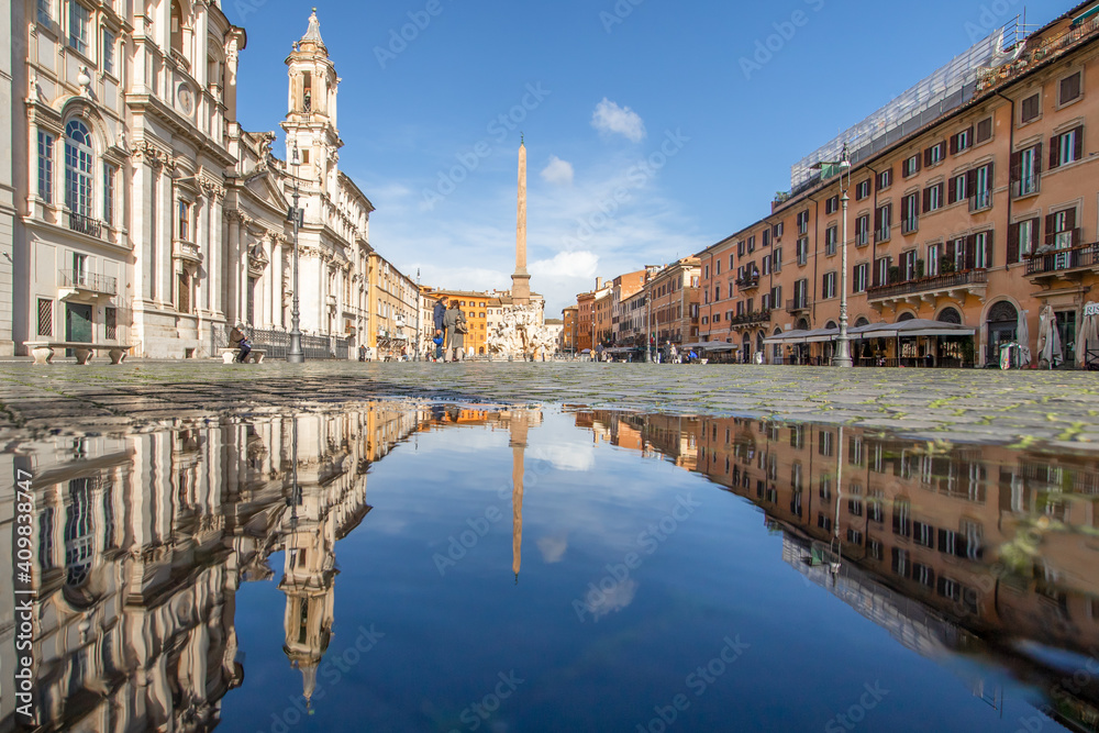
Rome, Italy - in Winter time, frequent rain showers create pools in which the wonderful Old Town of Rome reflect like in a mirror. Here in particular Piazza Navona