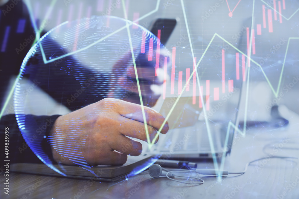 Double exposure of man's hands holding and using a phone and financial graph drawing. Analysis concept. Double exposure of man's hands holding and using a phone and financial graph drawing. Analysis concept.
