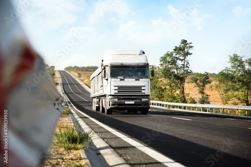 Beautiful view of asphalt highway with truck. Road trip