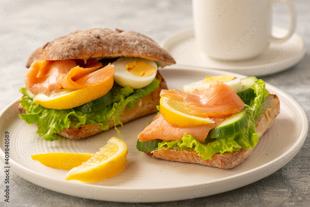 Sandwiches with smoked salmon, salad, cucumbers and eggs. Sandwiches with smoked salmon, salad, cucumbers and eggs.