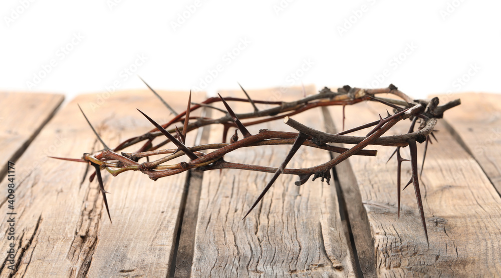 Crown of thorns on wooden table against white background, space for text. Easter attribute Crown of thorns on wooden table against white background, space for text. Easter attribute