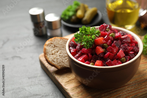 Traditional Russian salad vinaigrette served on grey table