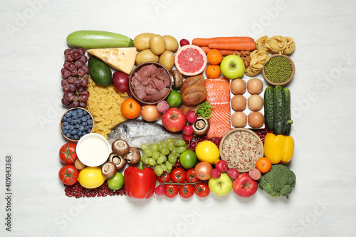 Fototapeta Naklejka Na Ścianę i Meble -  Different products on white table, top view. Healthy food and balanced diet