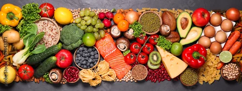 Obraz Different products on black table, top view. Healthy food and balanced diet