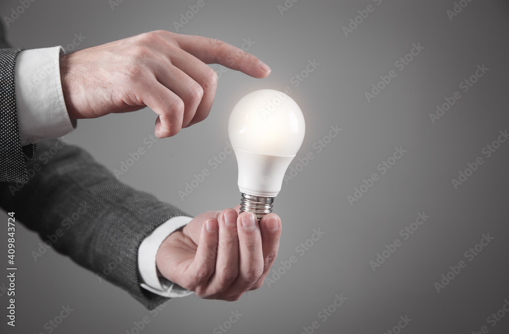 Man holding light bulb. Concept of inspiration and creativity Man holding light bulb. Concept of inspiration and creativity