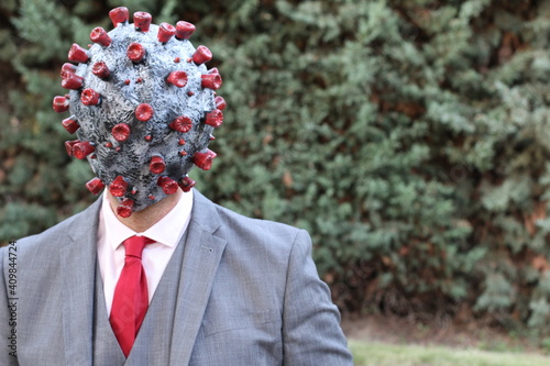 Businessman with rubber virus head