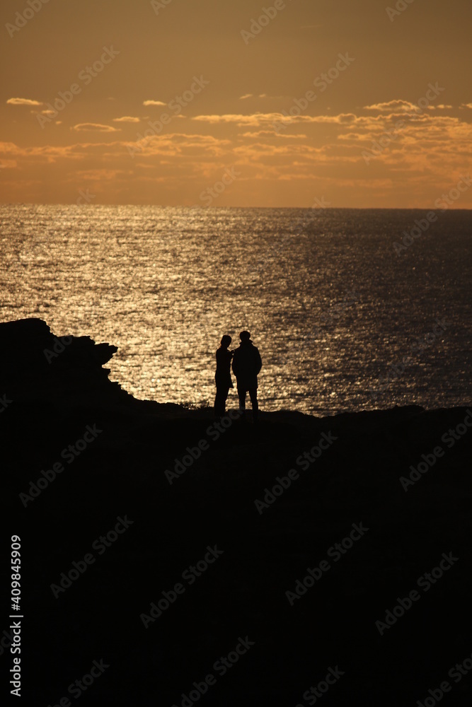 People against sunset in Sagres, Portugal