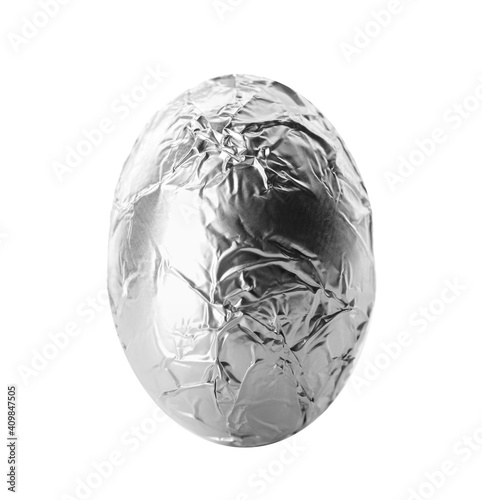 Chocolate egg wrapped in bright silver foil isolated on white