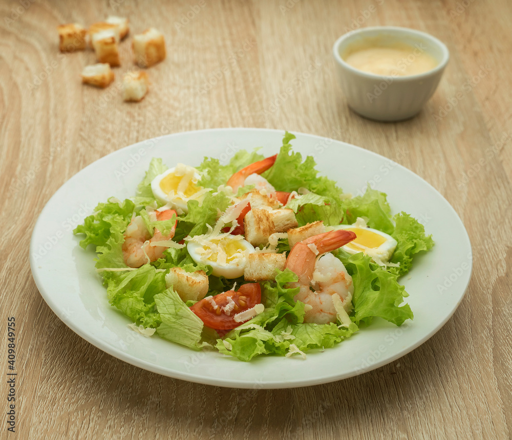 Caesar salad with shrimps and quail eggs