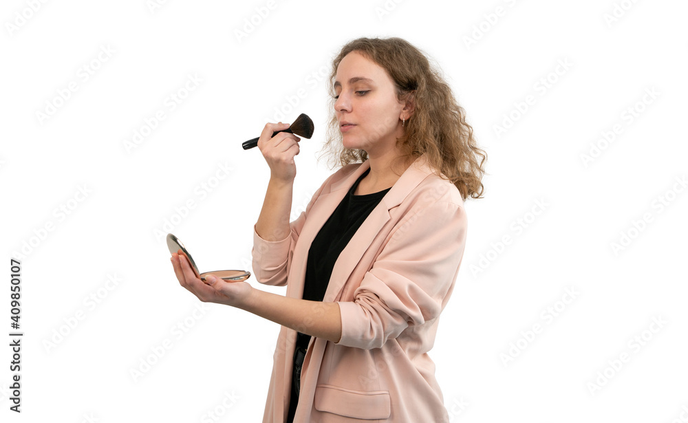 Woman in suit putting on makeup isolated on white background. Blonde curly hair. Woman in suit putting on makeup isolated on white background. Blonde curly hair.