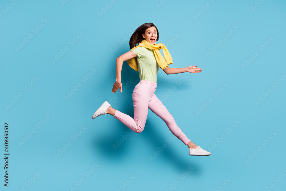 Full size profile portrait of crazy excited lady running open mouth unbelievable offer isolated on blue color background