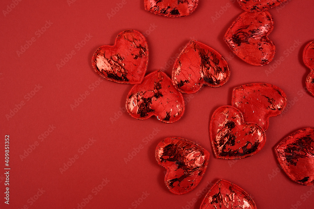 Fototapeta premium red textile small hearts on red background, festive background