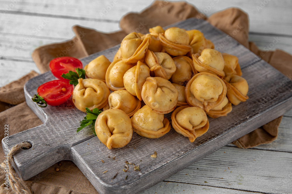 Deep-fried dumplings with garlic sauce on a white boards. 