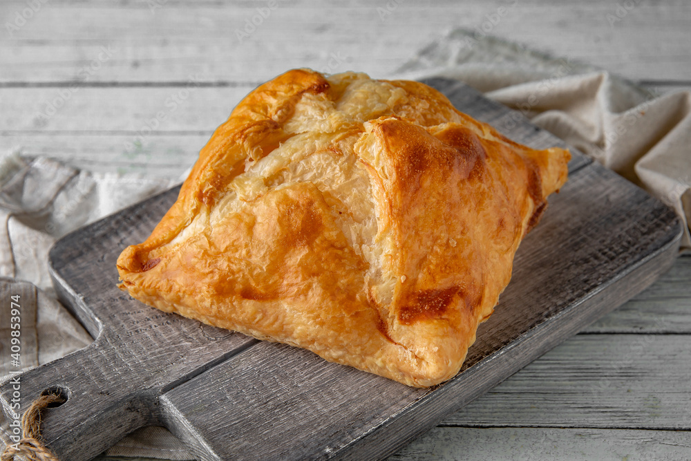 Puff pastry bun stuffed with apples, berries, or cottage cheese and potatoes, mini pie. Bakery products. Sweet pastry.