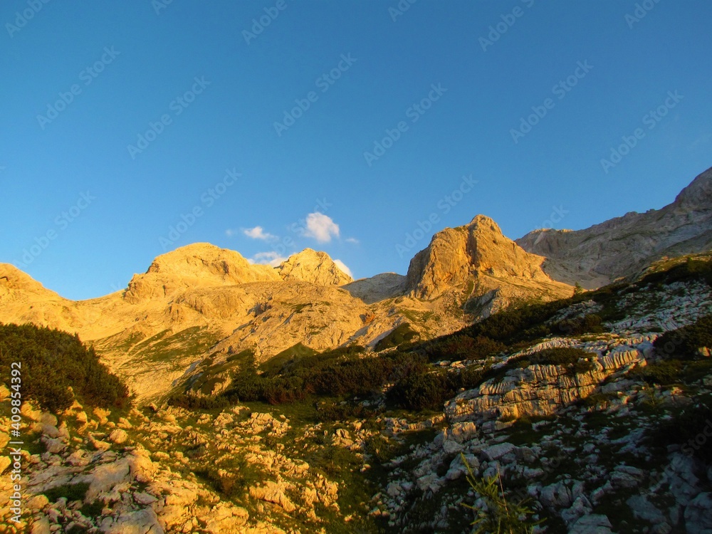 View of rocky alpine landscape bellow Triglav at sunrise in Julian alps and Triglav national park, Slovenia