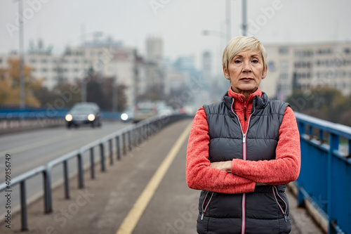 Portrait of sporty senior woman in city.