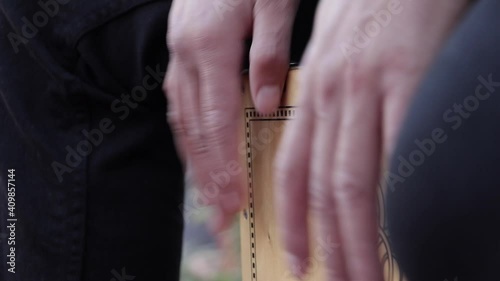 a percussionist playing the flamenco cajon instrument.