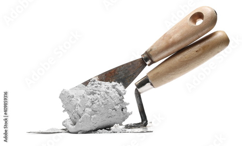 Old metal bricklaying trowel with wet cement, mortar isolated on white background photo