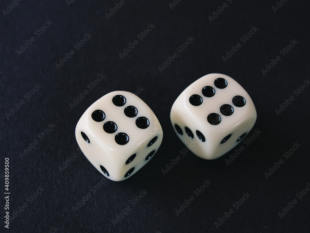 Close-up of two white dice against black background. Dice show double six Close-up of two white dice against black background. Dice show double six