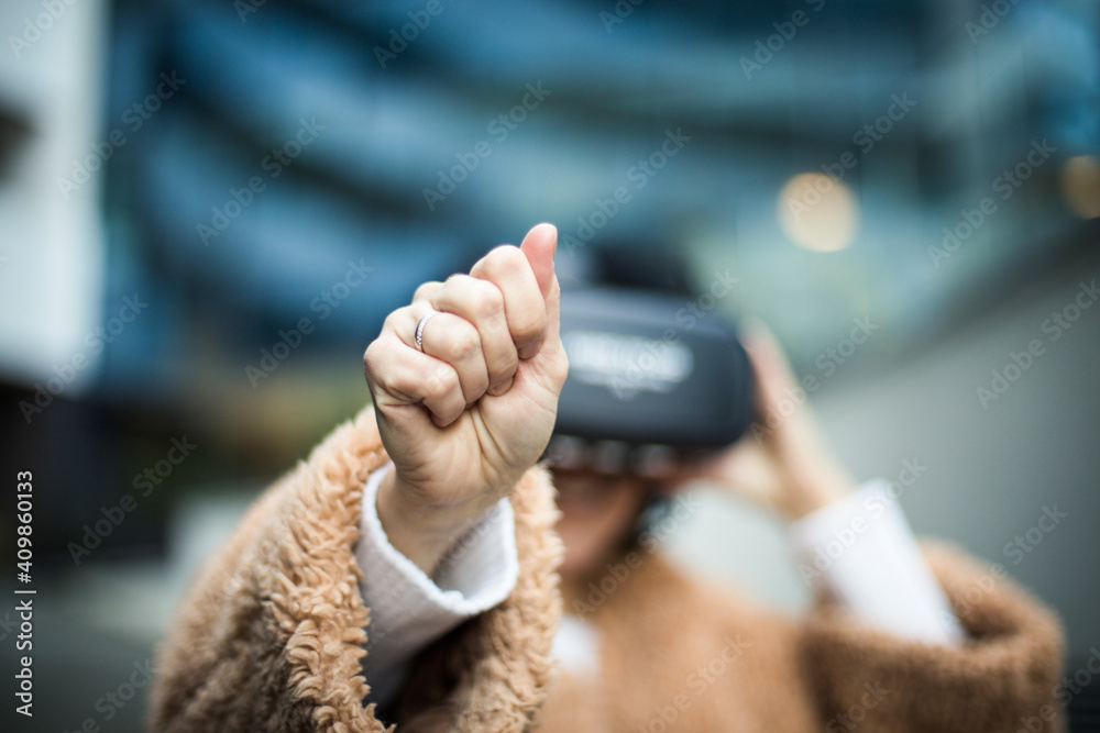 Young Woman With Virtual Reality Headset. Focus is on hand.