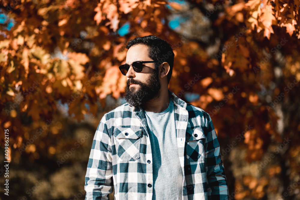 Single man outside in sunglasses plaid clothing autumn fall Single man outside in sunglasses plaid clothing autumn fall