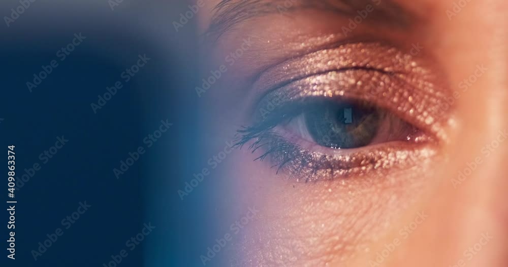 Eye extreme macro. Extreme close up shot of the woman's eye with make up and with smart phone reflection. Woman surfs the internet
