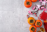 Top view of persimmons on gray table background for Chinese lunar new year