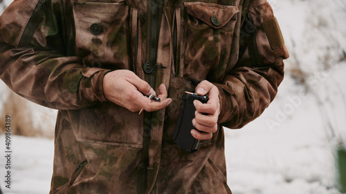 Uniform shooter loads 5.45mm rounds into the magazine for the Kalashnikov assault rifle