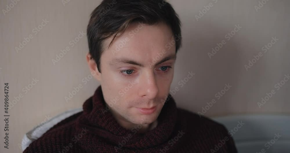 Pensive man looking at laptop screen in a bed Pensive man looking at laptop screen in a bed