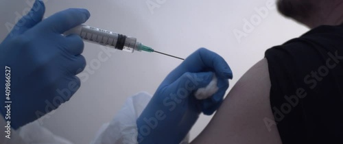 Man's arm being injected Vaccine