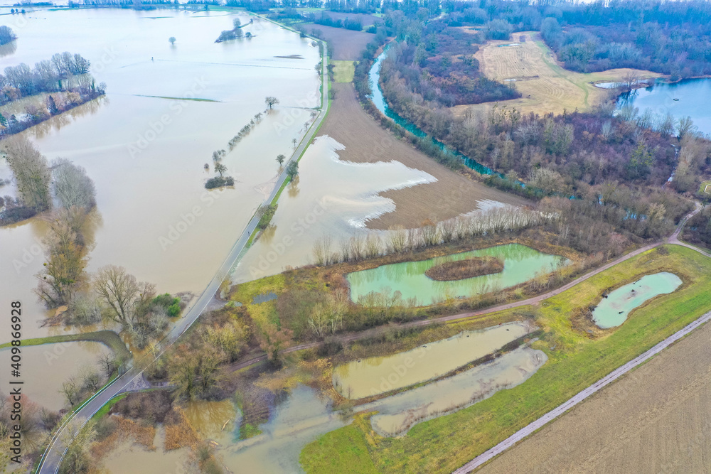 Drone photography of the flooded floodplains of the german Rhine River near Wörth, Maxau in Germany. Flood disaster in winter.