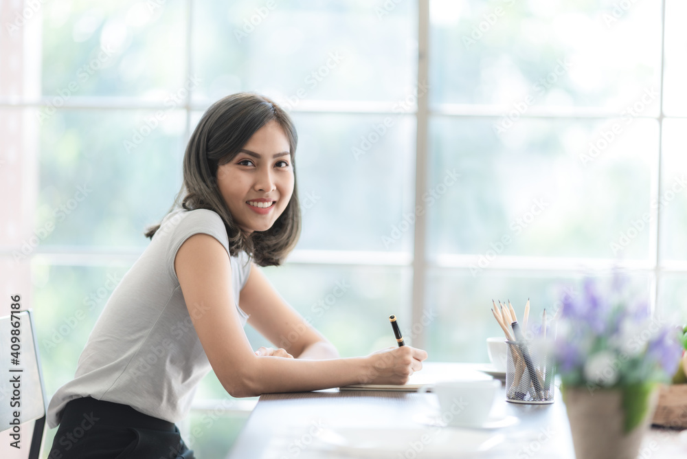 young Asian woman smiling to living at home, indoor lifestyle and working at home young Asian woman smiling to living at home, indoor lifestyle and working at home