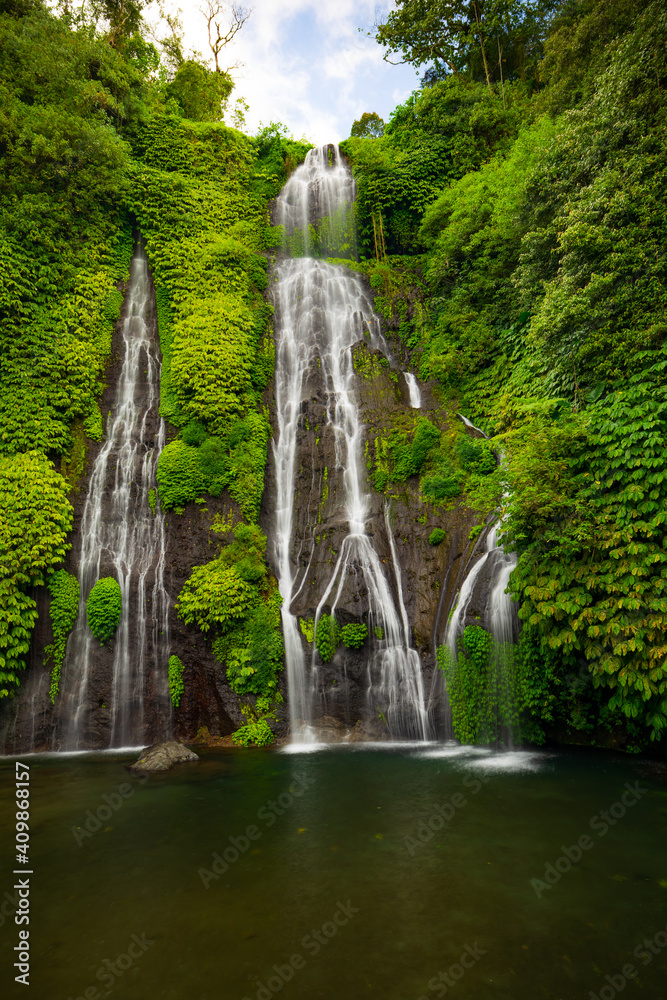 Hidden waterfall. Beautiful tropical landscape. Nature background. Adventure and travel concept. Natural environment. Slow shutter speed, motion photography. Banyumala waterfall, Bali, Indonesia