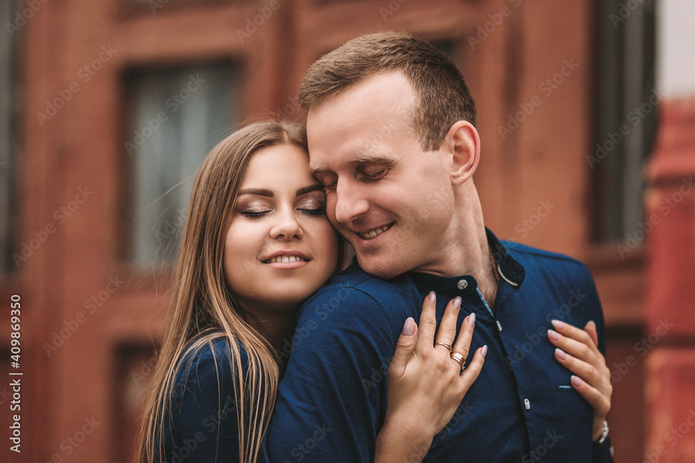 Happy couple hugging and smiling. Portrait of a guy and a girl with a smile on their faces.